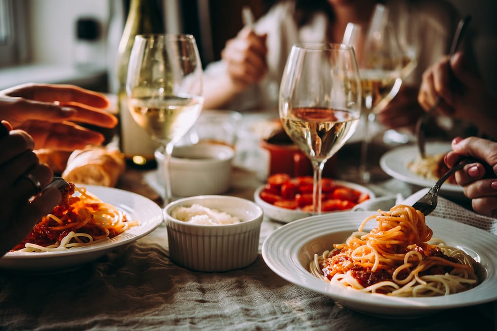 friends having pasta at an italian restaurant in acton, ma