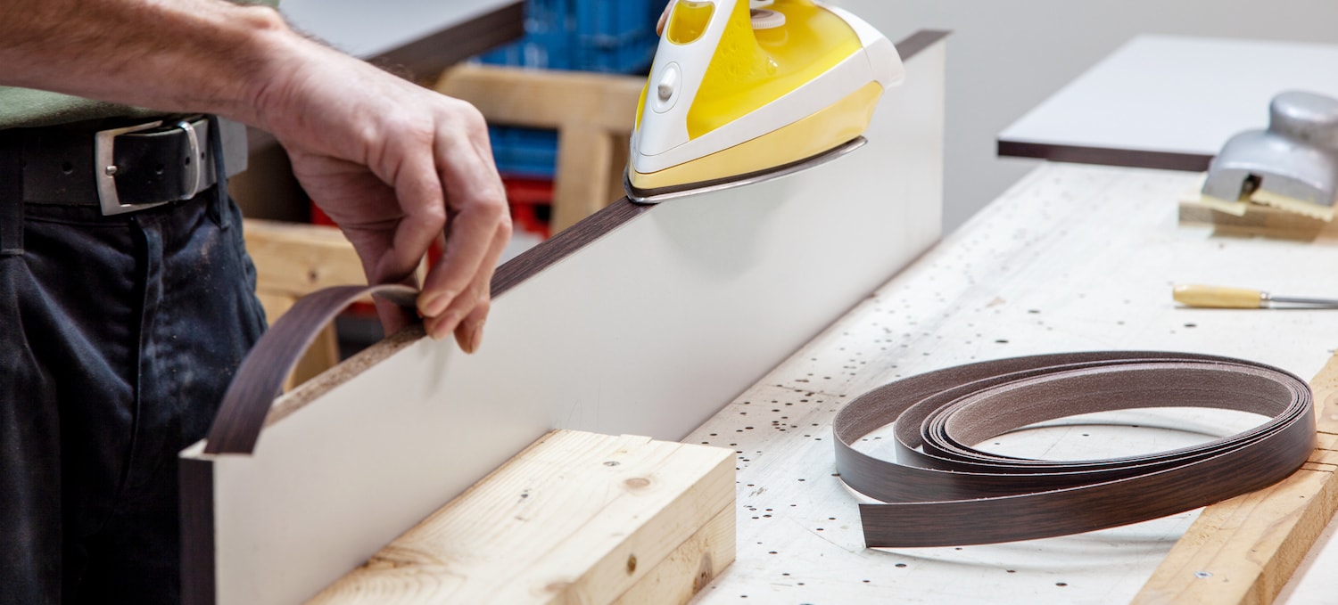 cutting and applying wood veneer to cabinets